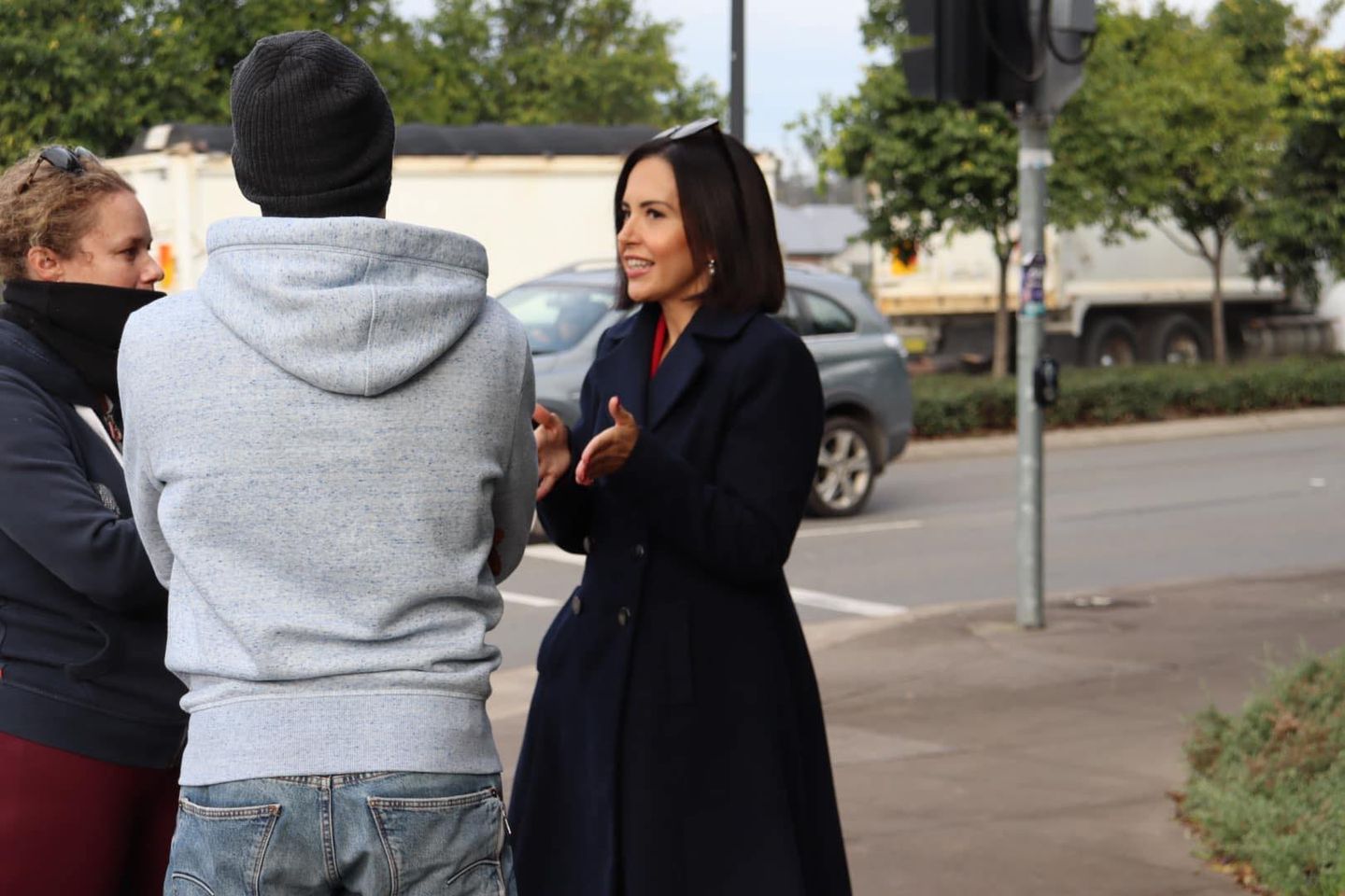 Image shows NSW Deputy Premier Prue Car speaking with two people on a street corner.