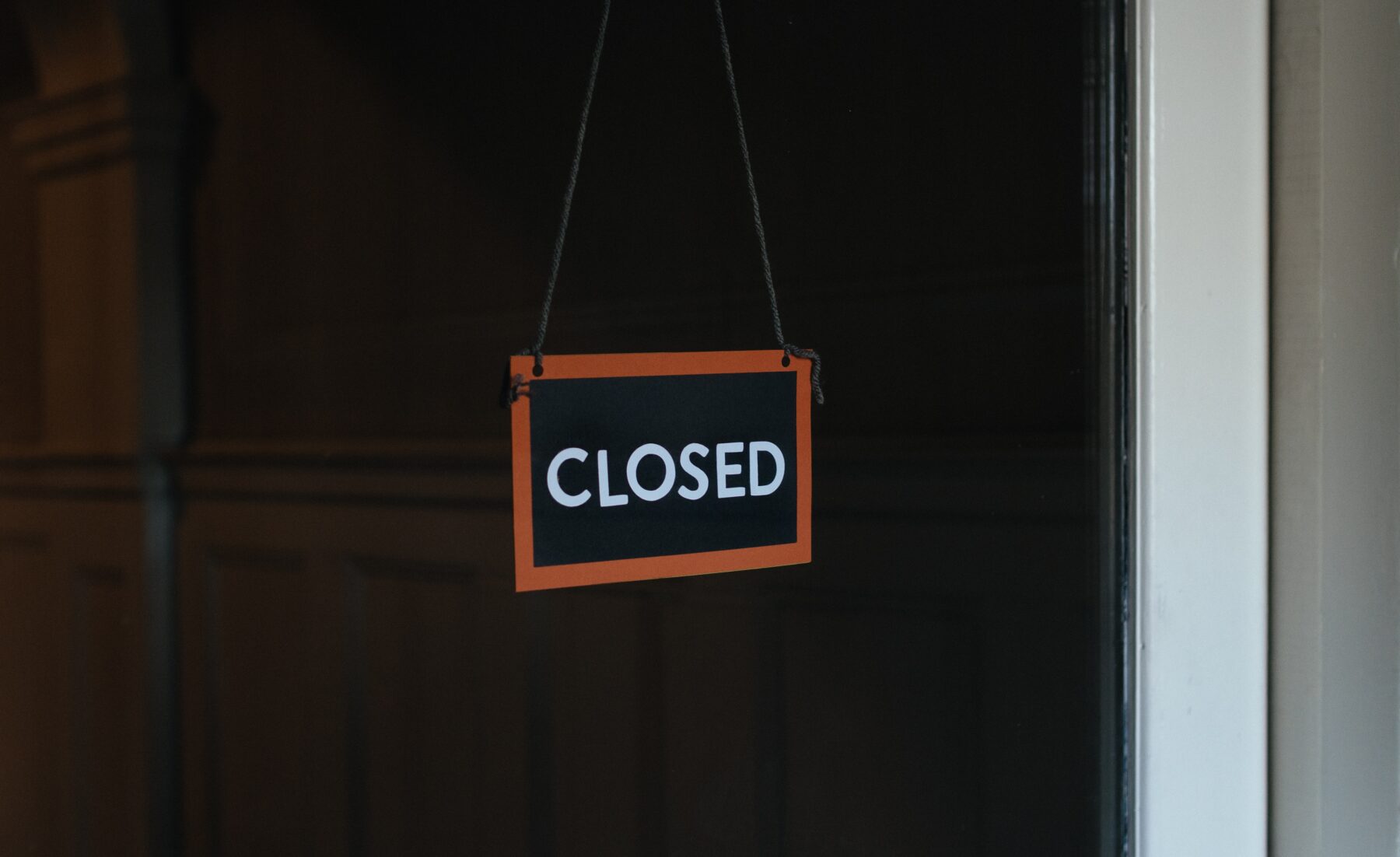 A closed sign is shown against a black background